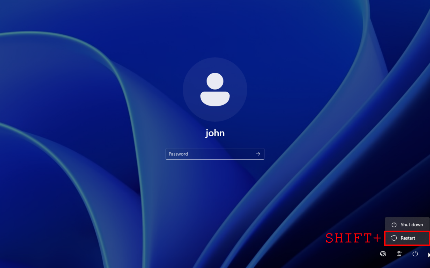 Windows 11 login screen showing the Shift Restart option to boot into recovery mode