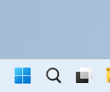 Windows 11 taskbar with the search icon next to the Start button and pinned apps.